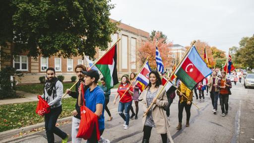 International club carrying flags during homecoming parade